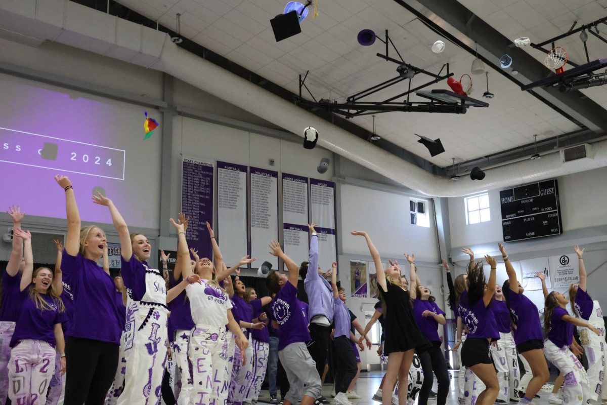 Seniors throw up their hats while dancing to High School Musical